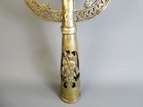 a gold colored hand held mirror with a bird on it