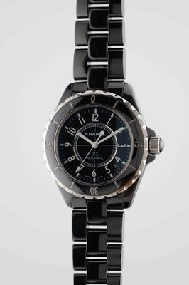 the watch is black and silver with a black face