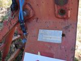 a sign on the back of a tractor that is rusting