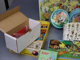 a box of children ' s books and other toys on a table