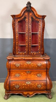 an old wooden dresser with a mirror on top of it