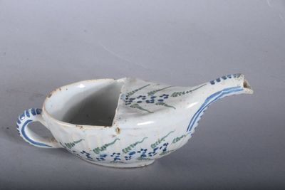 a small blue and white bird shaped bowl on a table
