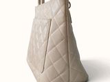 a white purse that is sitting on a white surface