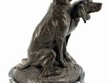 bronze statue of two dogs sitting on a marble base