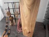 a wooden stand with a phone on top of it next to other items