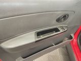 a red car door handle with a radio in it