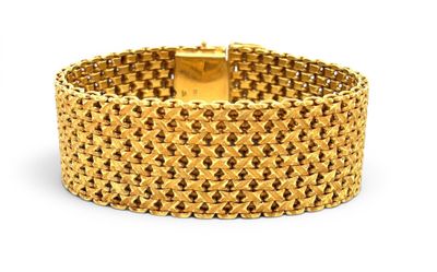 a close up of a gold bracelet on a white background