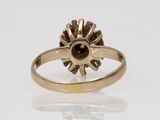 a gold ring with a brown stone in the center