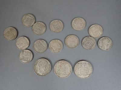 several silver coins are arranged in a circle on a gray surface