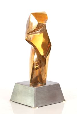 sculpture of a golden sculpture on a silver base on a white surface