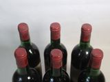 several bottles of wine are lined up on a table