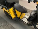 a scooter that is parked on the side of the street