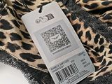 a close up of a leopard print bra top with a price tag