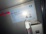 a sign on the side of a refrigerator with a light on it