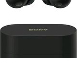 a pair of black earphones sitting on top of a black box
