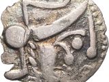 gros plan d'une pièce d'argent sur laquelle figure un homme