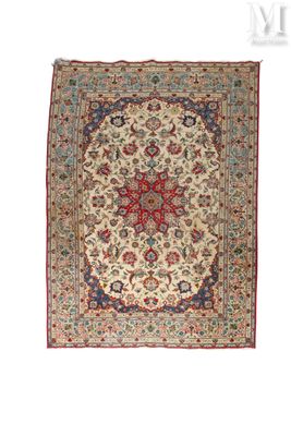 an antique persian rug with a medallion design on a cream ground