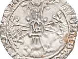 a close up of a silver coin with a skull and cross on it