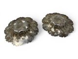 pair of silver plated shells with holes in the middle