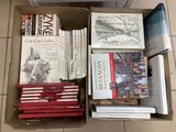 many books in a box on the floor