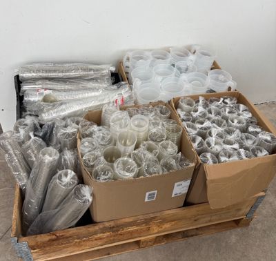 several boxes filled with different types of plastic items sitting on a pallet