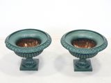 two green vases sitting next to each other on a table