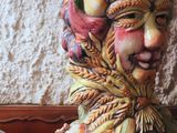 a ceramic figurine of a man with fruit on his head