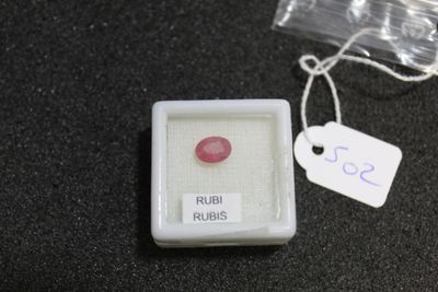 a small box with a pink stone inside of it