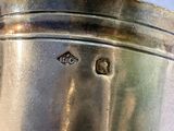 a close up of a silver cup on a table