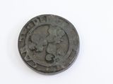 a close up of a coin on a white surface