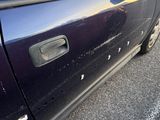 a car that has been damaged and is parked on the side of the road