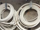 a lot of white hoses that are laying on the floor