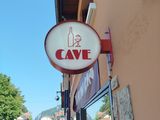 a sign that says cave on the side of a building