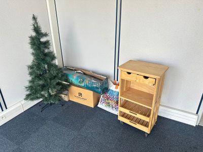 a small christmas tree next to a small wooden shelf