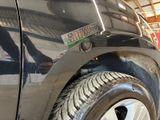 a close up of a car ' s tire with a sticker on it