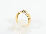an image of a gold ring with two black diamonds on it