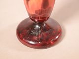 a red vase that is sitting on a table