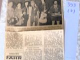 a newspaper with a picture of a group of people on it