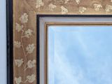 a picture of a mirror with a sky in the background