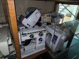 many sewing machines sitting on a shelf in a room