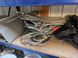 a pile of rope and other items on a shelf