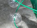 a green umbrella with three clear bubbles attached to it