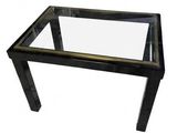a black glass coffee table with a metal frame and glass top