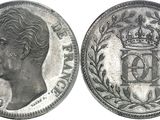 a close up of a silver coin with a crown on it