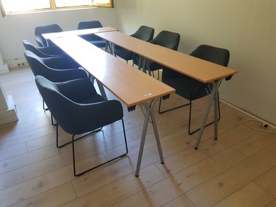 a long table with chairs around it in a room