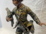 statue en bronze représentant un garçon tenant un oiseau dans la main