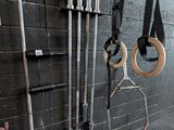 a wall with a bunch of gym equipment hanging on it