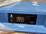 a blue machine that is sitting on top of a table