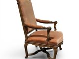 an old fashioned chair with a brown upholstered seat