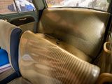 a seat in the back of a car with a blue seat cushion